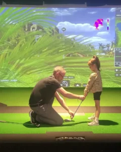 image of a man holding a golf club with a child showing how golf does burn a lot of calories for all ages